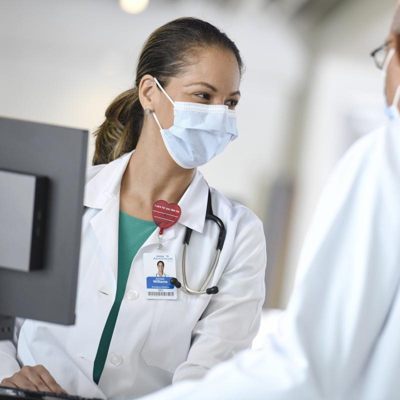 An AdventHealth team member talking with a patient.