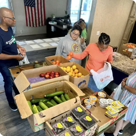 Desmond Haye, director of pastoral care and volunteer services at Texas Health Mansfield, is seen volunteering during the Mobile Market 2 Go Program.